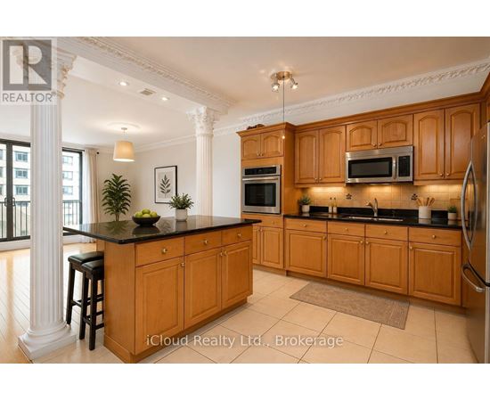 A kitchen with wooden cabinets and a black countertop.