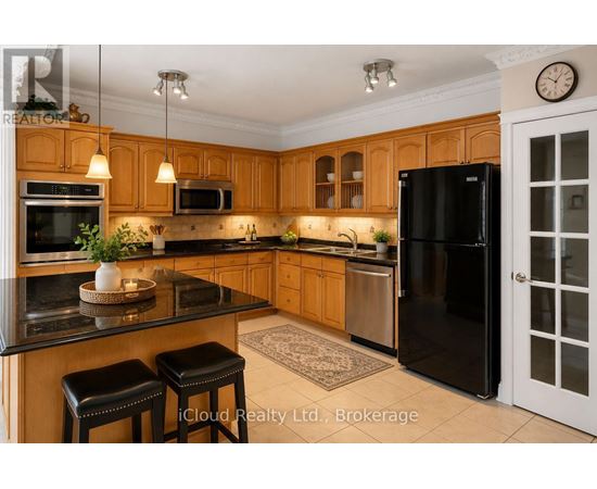 A kitchen with wooden cabinets and black appliances.