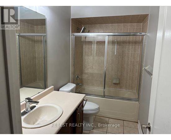 A bathroom with a sink, toilet, and shower.