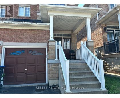 A house with a brown garage door and a white porch.