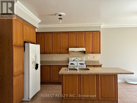 A kitchen with wooden cabinets and a white refrigerator.