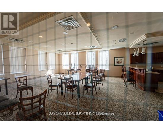 A dining room with a table set for six with chairs around it.