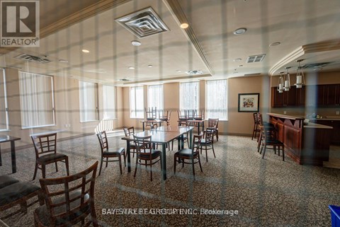 A dining room with a table set for six with chairs around it.