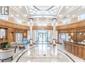 A spacious lobby with a reception desk and a fireplace.