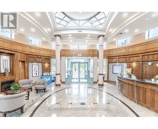 A spacious lobby with a reception desk and a fireplace.