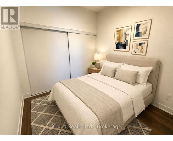 A bedroom with a large bed and a lamp on the side table.