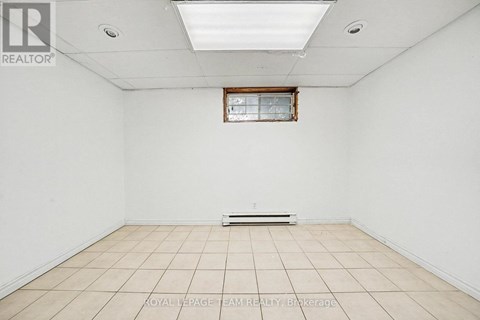 A white room with a window and a skylight.