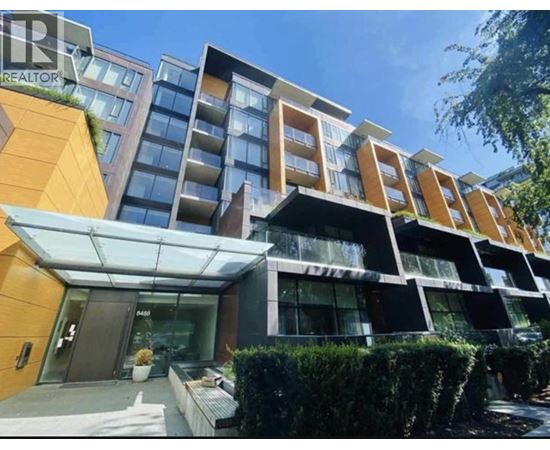 A modern multi-story building with a glass entrance and a sign that reads "REALTOR".