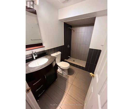A bathroom with a sink, toilet and shower.