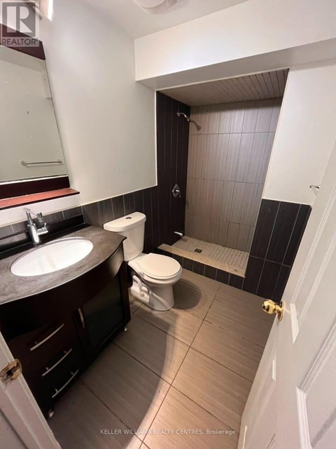 A bathroom with a sink, toilet and shower.