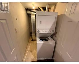 A white washing machine in a small laundry room.