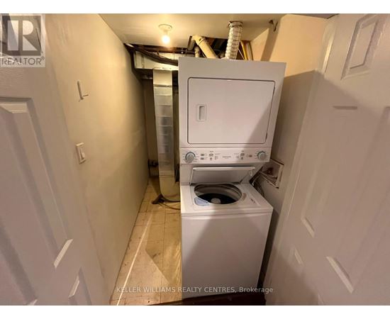 A white washing machine in a small laundry room.