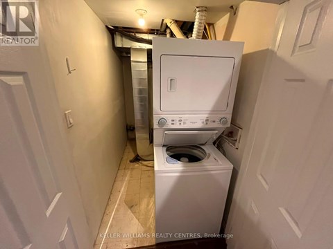 A white washing machine in a small laundry room.