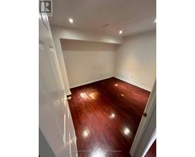 A room with wooden floors and white walls.