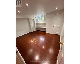 A room with a wooden floor and white walls.