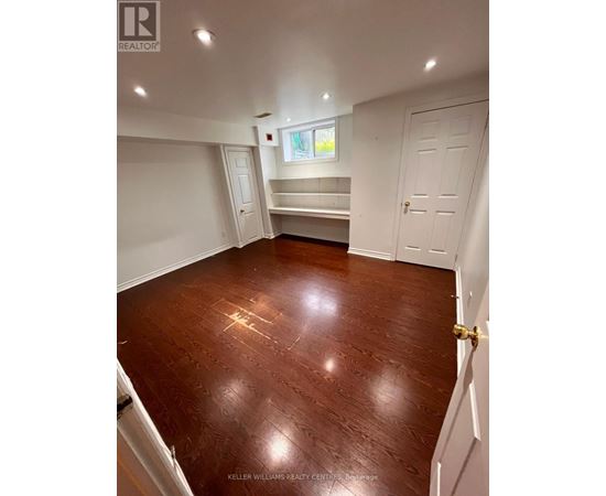 A room with a wooden floor and white walls.