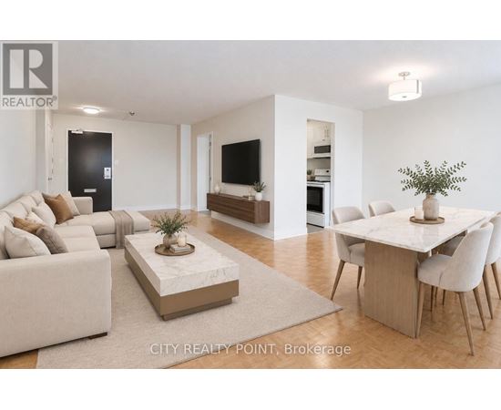 A living room with a white couch, a coffee table, and a dining table with chairs.