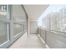 A balcony with a railing and a view of buildings in the distance.