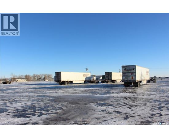 A group of trucks are parked in a lot.