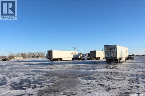 A group of trucks are parked in a lot.