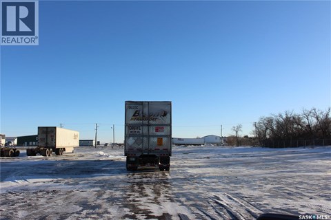 A white box truck with the word "DRIVE" on the side is parked in a snowy lot.