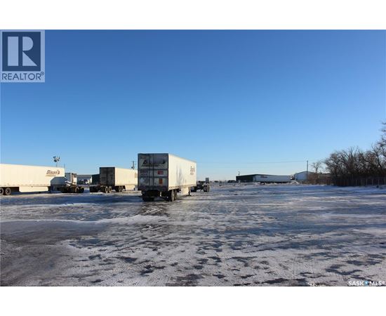 A large white truck is parked in a snowy lot.