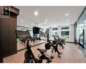 A gym with exercise bikes and a television.