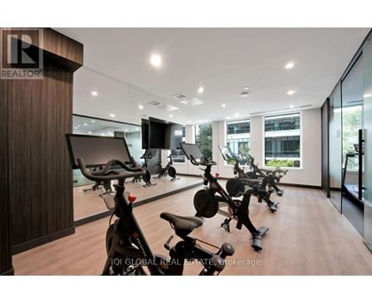 A gym with exercise bikes and a television.