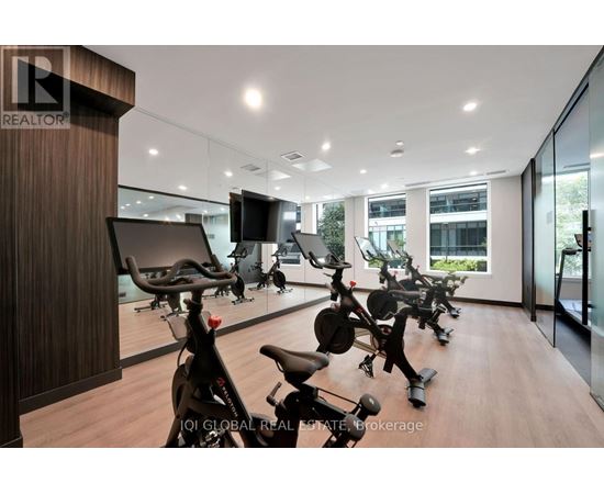 A gym with exercise bikes and a television.