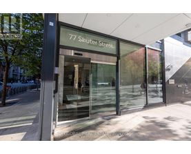 The image shows the front of a building with the address 77 Shuter Street.
