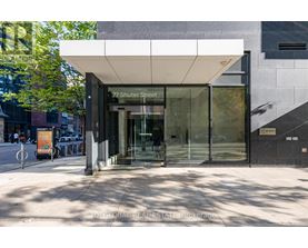 The image shows the front of a building with a glass entrance and a sign that reads "77 Shuter Street".