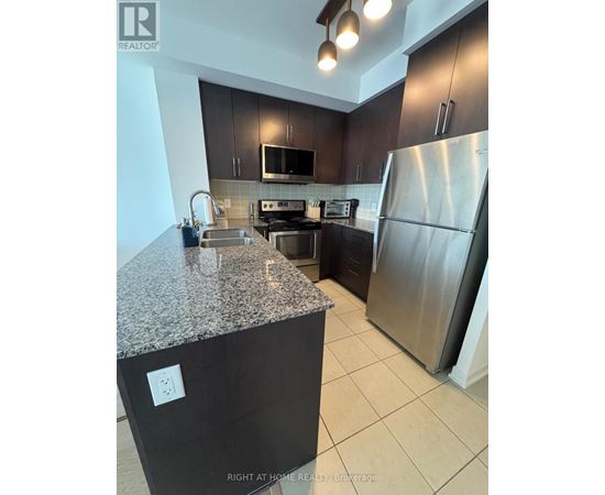 A kitchen with granite countertops and stainless steel appliances.