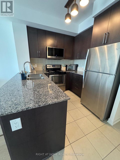 A kitchen with granite countertops and stainless steel appliances.