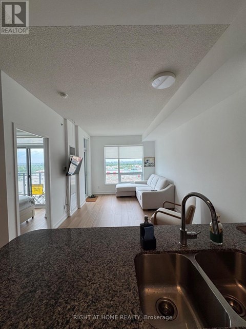 A kitchen with a sink and a window.