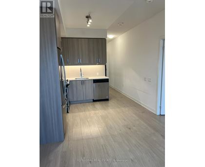 A kitchen with a sink and cabinets is shown in this image.