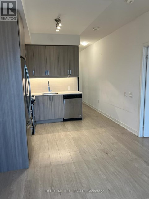 A kitchen with a sink and cabinets is shown in this image.