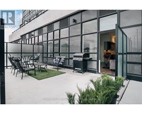 A patio area with a table and chairs outside a building.