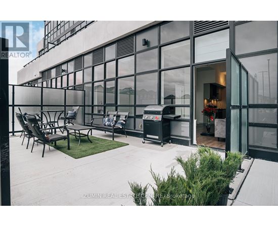 A patio area with a table and chairs outside a building.
