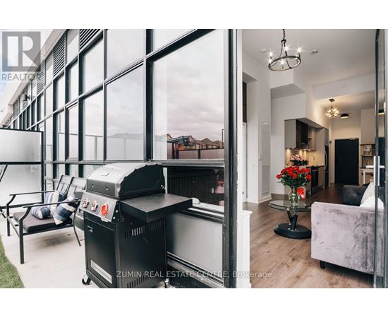 A modern living room with a barbecue grill and a view of the outdoors.