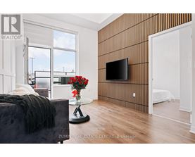 A modern bedroom with a large bed and a flat screen TV mounted on the wall.