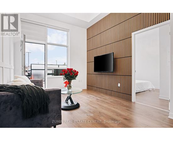 A modern bedroom with a large bed and a flat screen TV mounted on the wall.