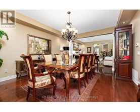 A dining room with a wooden table and chairs.