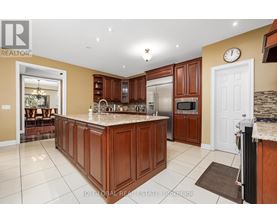 A kitchen with brown cabinets and a granite countertop.