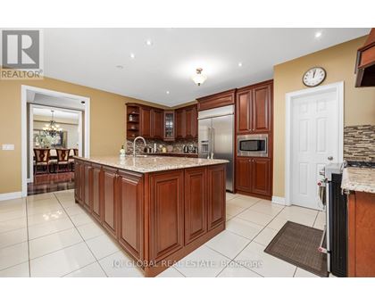 A kitchen with brown cabinets and a granite countertop.