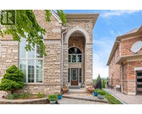 A house with a stone facade and a large arched entrance.