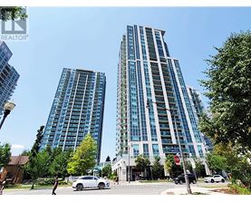 Two tall buildings are situated next to each other.