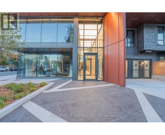 The image shows the front of a building with a glass facade and a red pillar with the number 28 on it.