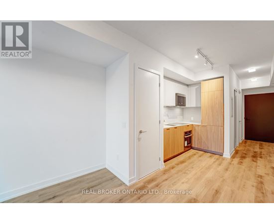 A room with a white wall and a wooden floor.