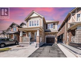 A modern two-story house with a garage is for sale.