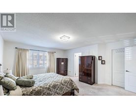A bedroom with a bed, dresser, and nightstand.